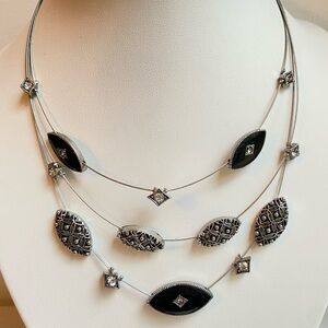 Floating necklace on layered silvertone wire with rhinestones and black enamel